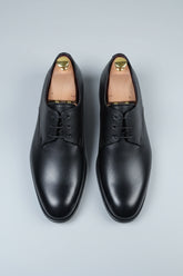 Black leather lace-up dress shoes with a classic design and smooth finish.